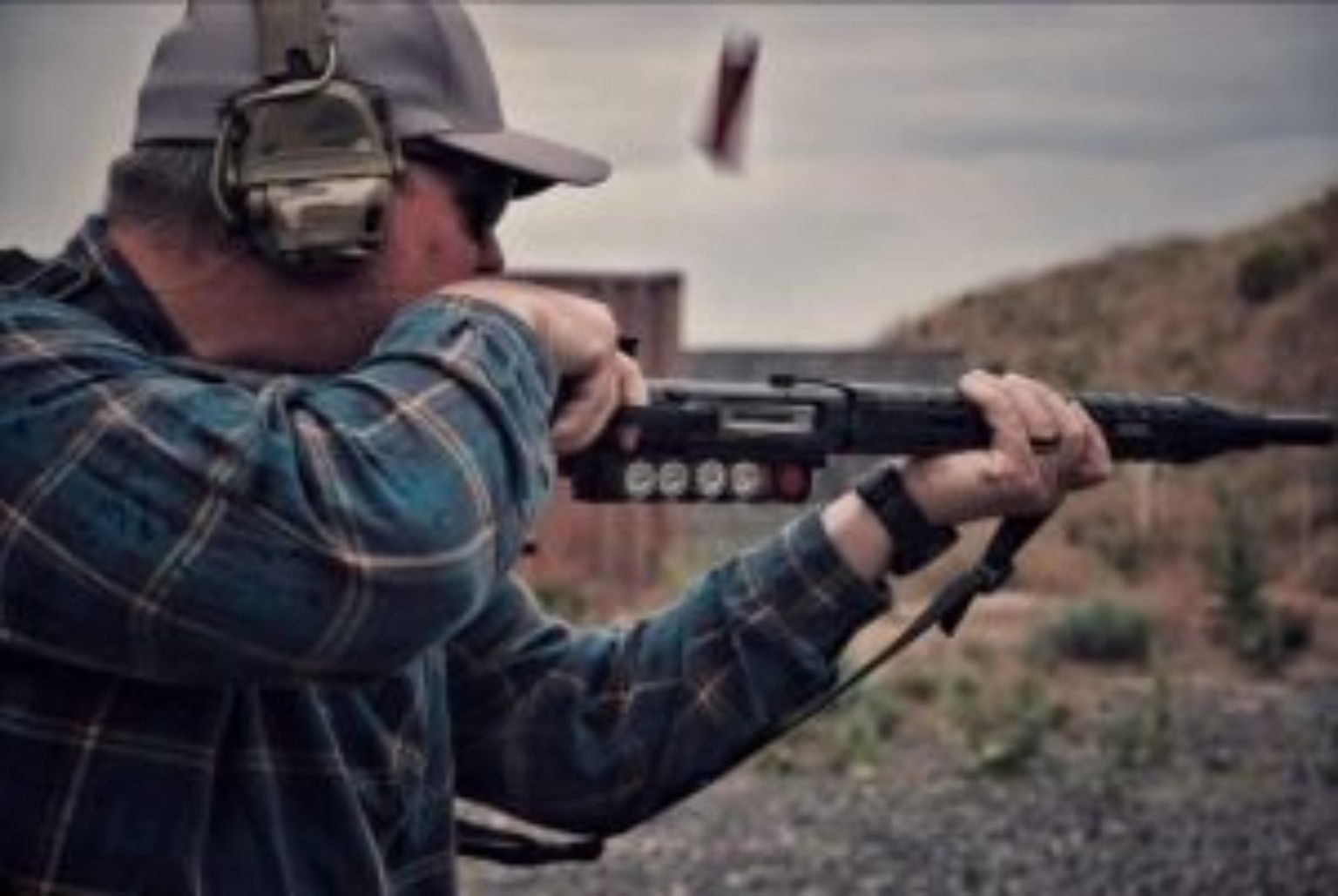 Matt Landfair demonstrating a short-stock shotgun technique during live-fire training.